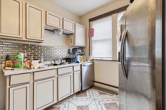 kitchen with decorative backsplash, light tile patterned floors, and stainless steel appliances