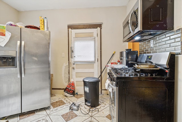 kitchen featuring decorative backsplash, light tile patterned flooring, and stainless steel appliances