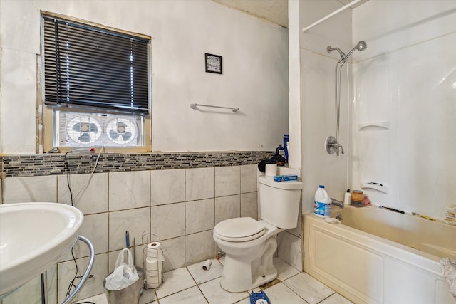 full bathroom with sink, shower / bathtub combination, tile walls, and toilet