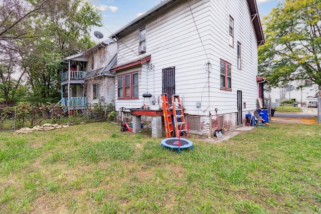 rear view of house featuring a lawn