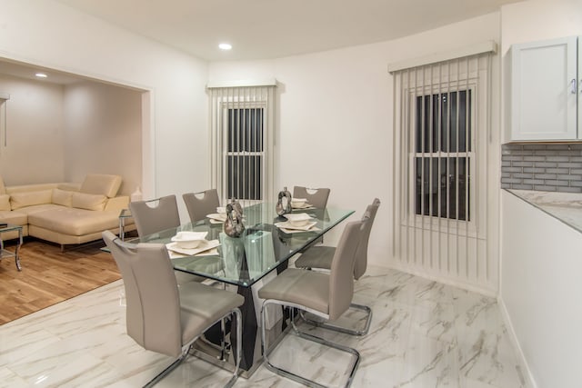 dining space with light hardwood / wood-style flooring