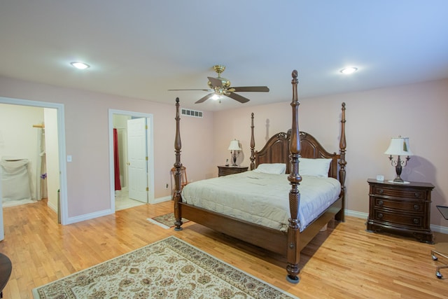 bedroom with ensuite bathroom, light hardwood / wood-style flooring, and ceiling fan