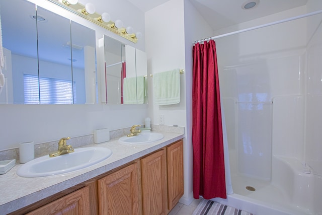 bathroom featuring curtained shower and vanity