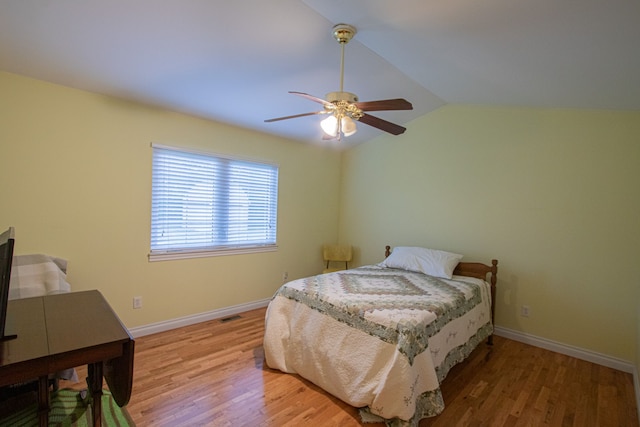 bedroom featuring ceiling fan, lofted ceiling, and hardwood / wood-style flooring