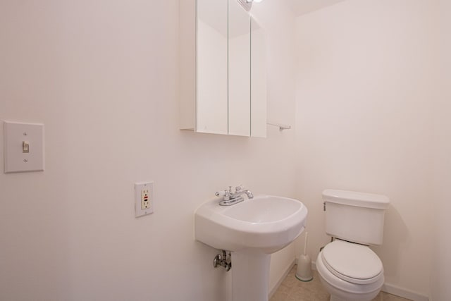 bathroom featuring tile patterned flooring and toilet