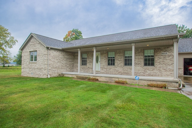 view of front of house with a porch and a front yard