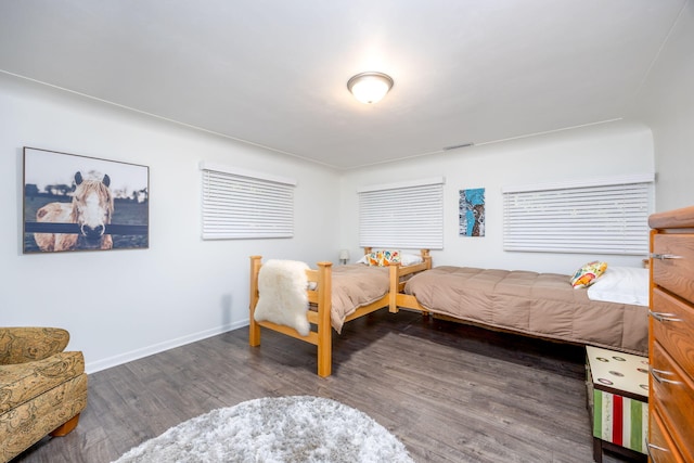 bedroom with dark hardwood / wood-style flooring