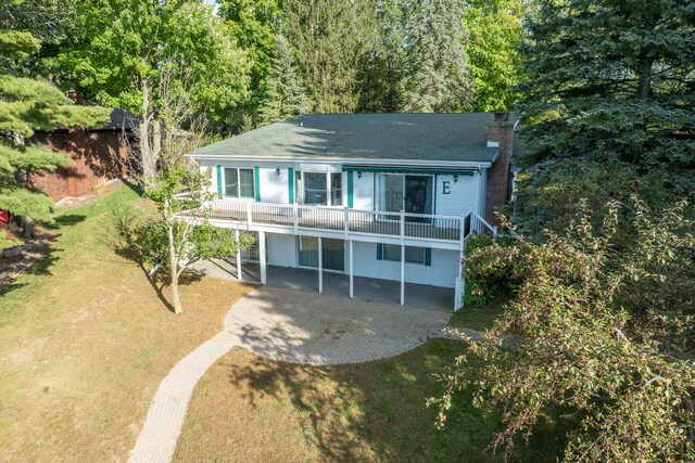 rear view of property featuring a yard and a patio