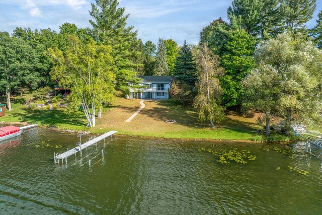 exterior space with a water view and a lawn