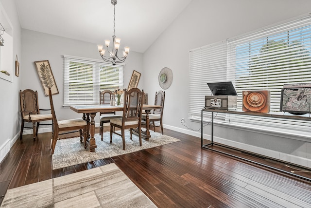 dining area featuring a chandelier, dark hardwood / wood-style floors, and vaulted ceiling