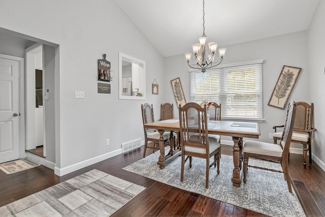 dining area with a notable chandelier, dark hardwood / wood-style flooring, and lofted ceiling