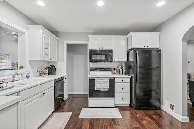 kitchen featuring black appliances, dark hardwood / wood-style flooring, white cabinetry, and sink