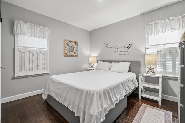 bedroom featuring dark hardwood / wood-style flooring and multiple windows