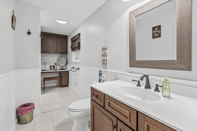 bathroom featuring tile patterned flooring, vanity, and toilet