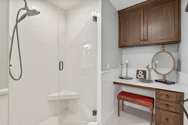 bathroom featuring tile patterned flooring and a shower with shower door