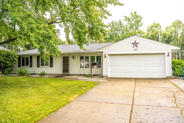 single story home with a garage and a front lawn