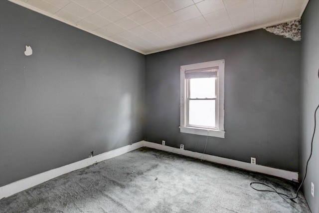 carpeted spare room with crown molding