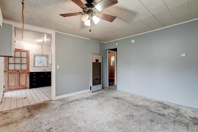 carpeted empty room featuring ceiling fan and ornamental molding