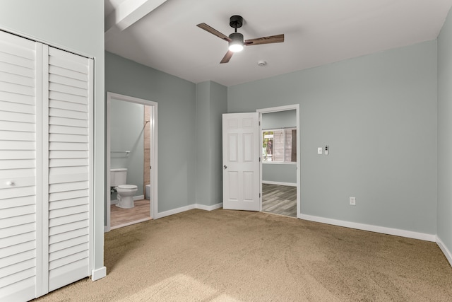 unfurnished bedroom featuring connected bathroom, ceiling fan, a closet, and carpet floors