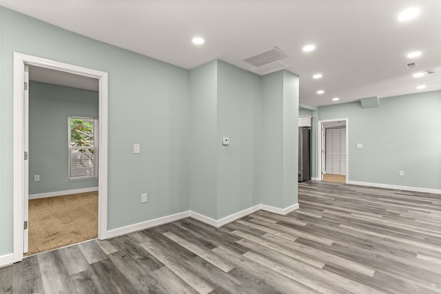 empty room with hardwood / wood-style flooring