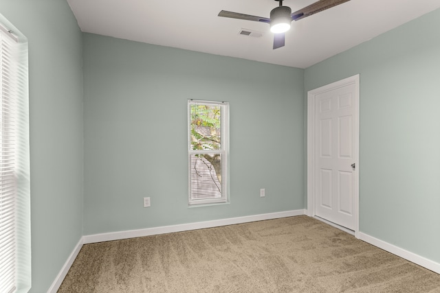 unfurnished room featuring ceiling fan and carpet floors