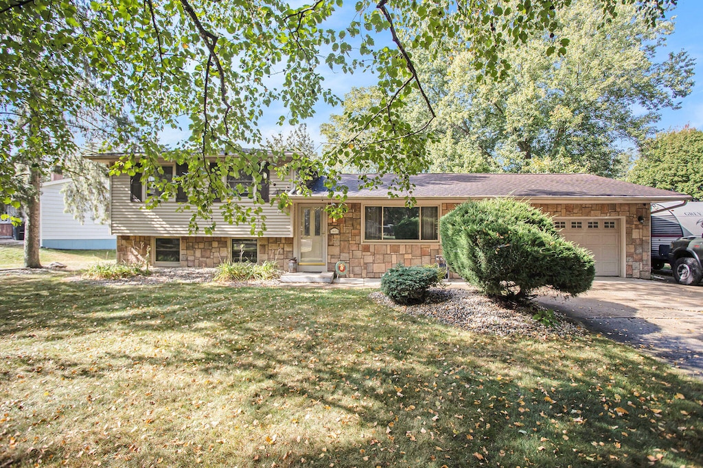 view of front of property featuring a garage and a front lawn