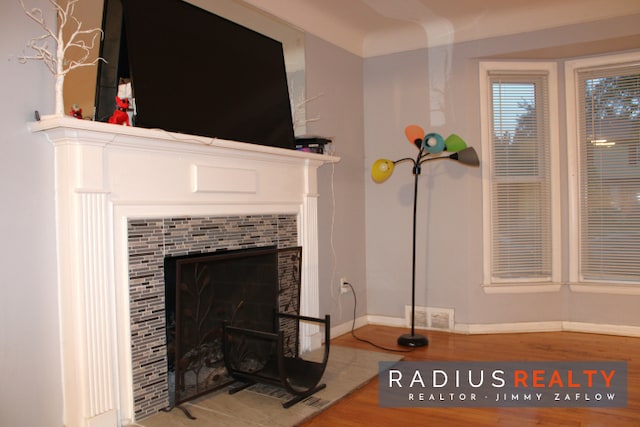 interior details featuring hardwood / wood-style flooring and a fireplace