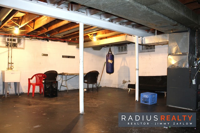 basement with heating unit and sink