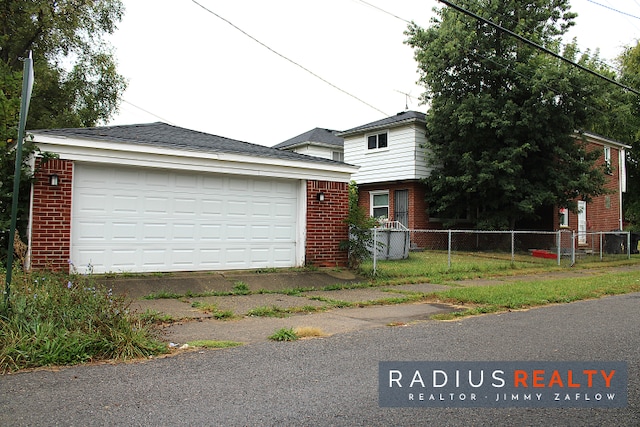 view of front facade featuring a garage and an outdoor structure