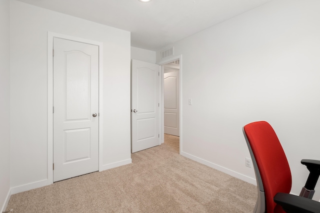 unfurnished office featuring light colored carpet