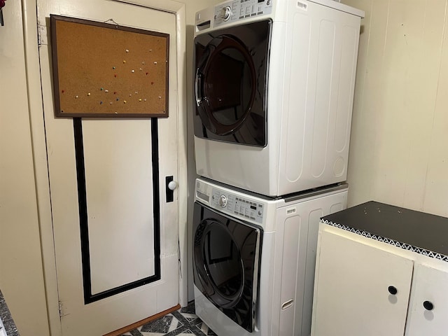 laundry room featuring stacked washer and clothes dryer