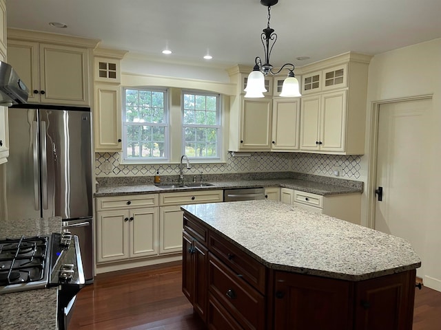 kitchen featuring dark brown cabinetry, sink, a kitchen island, and dark hardwood / wood-style floors