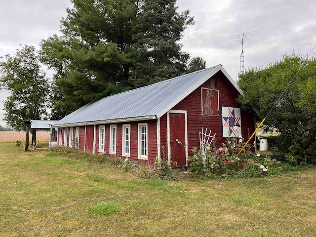 view of outdoor structure featuring a lawn