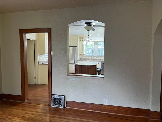 spare room with wood-type flooring and ceiling fan