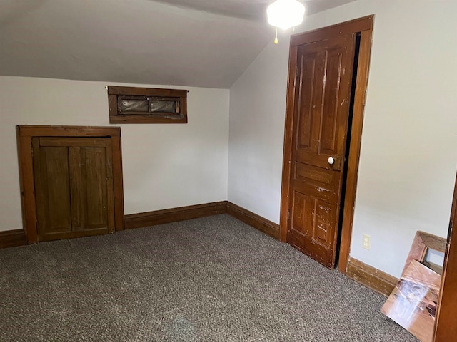 additional living space featuring carpet flooring and lofted ceiling