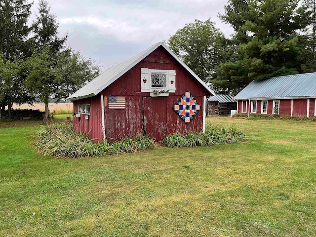 view of outbuilding featuring a lawn