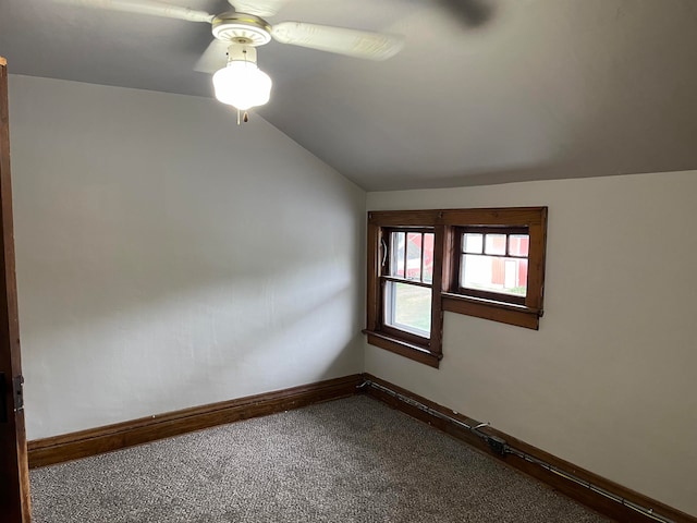 empty room featuring carpet, vaulted ceiling, and ceiling fan