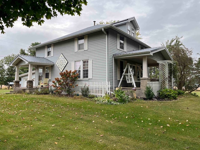 view of home's exterior with covered porch and a yard