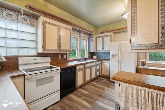 kitchen featuring hardwood / wood-style floors, white appliances, tasteful backsplash, and sink