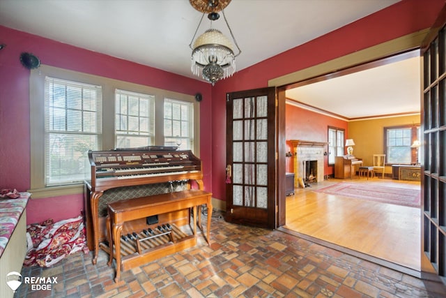 miscellaneous room featuring a notable chandelier, crown molding, and french doors