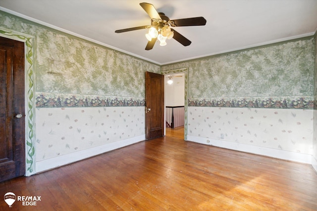 unfurnished room featuring ceiling fan, wood-type flooring, and crown molding