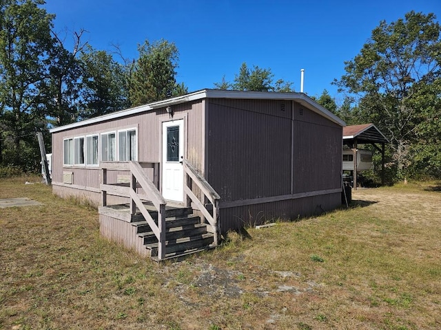 rear view of property with a lawn