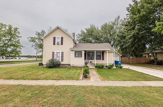 view of front of house with a garage and a front lawn