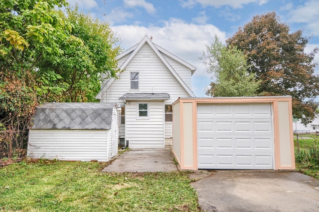 view of front facade featuring a garage and an outdoor structure