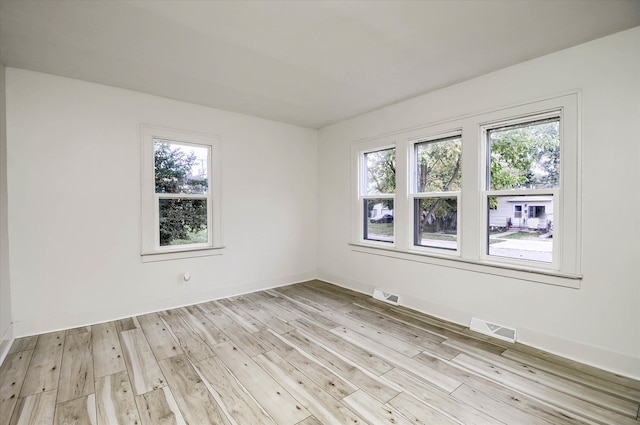 unfurnished room with light hardwood / wood-style flooring