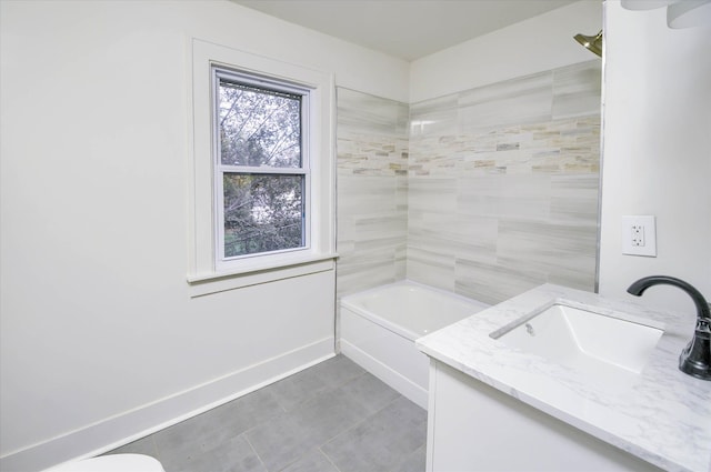 bathroom with tile patterned flooring, vanity, and tiled shower / bath