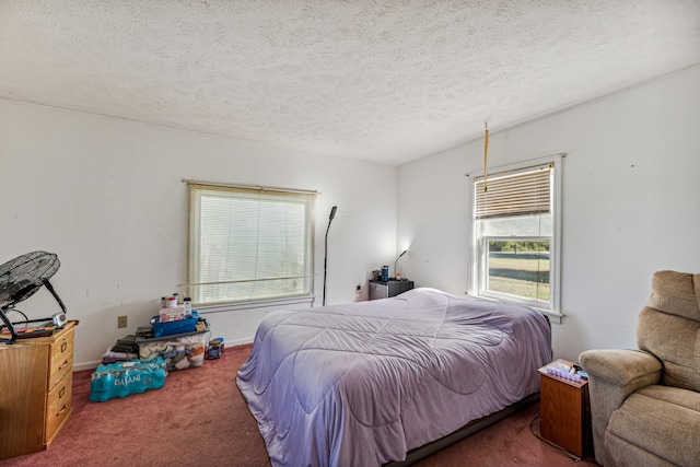 bedroom featuring carpet and a textured ceiling