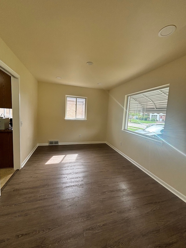 unfurnished room featuring dark hardwood / wood-style floors