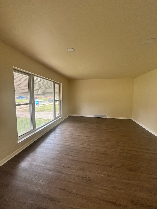 spare room featuring dark wood-type flooring