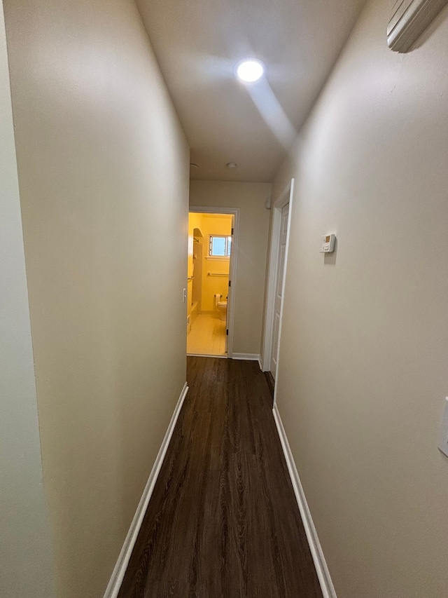 hall with dark hardwood / wood-style floors and a wall mounted AC